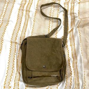 Olive green cross body bag with multiple pockets and a lot of storage room